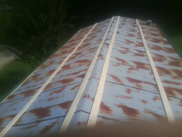 Rusted metal roof panels with new wood purlins before replacement — Storm Damage Roof Repair in Payette by Roofing Brothers